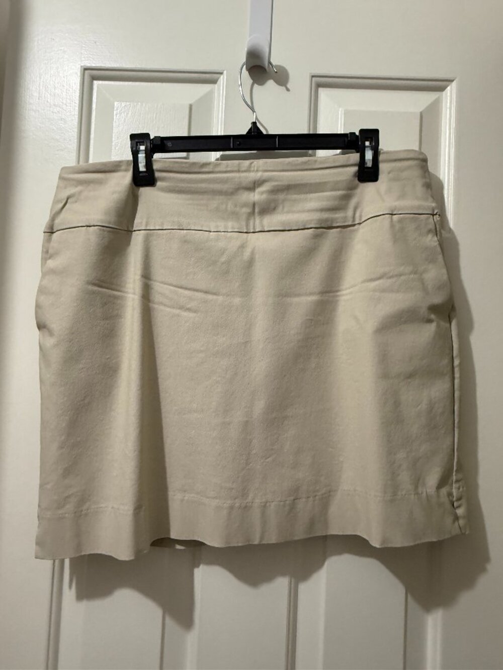Womens tan straight skort, with front and back pockets.